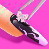 Long stiletto acrylic nails with purple ombre and moon decals on a pink background
