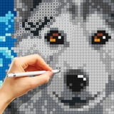 Color by number and cross-stitch your way to calm Majestic wolf being cross-stitched in